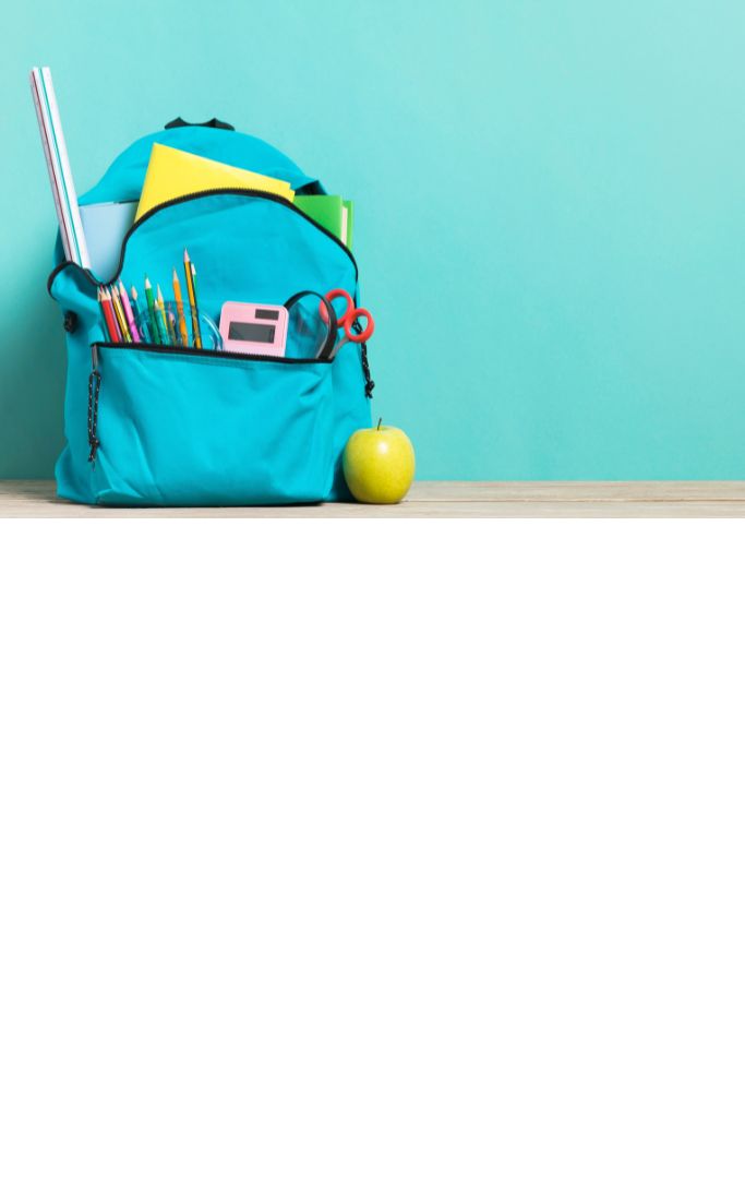 Blue backpack with supplies and blue backdrop.